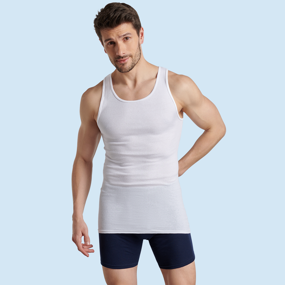 Big and tall male model wearing fruit of the loom undershirt and boxer briefs eating breakfast